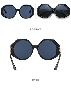 Detailed views of black oversized polygon sunglasses with blue lenses and gold trim