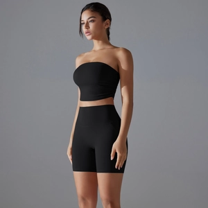 Detail view of high-waist yoga shorts and black tube top showing fit and fabric texture