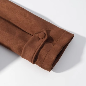 Detailed close-up of dark brown suede coat cuffs with matching fabric-covered buttons