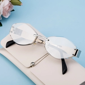 Fashion rimless sunglasses with diamond cut edges and silver metal frame on a beige case