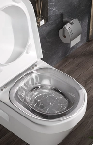 Detailed view of a transparent rimless bidet for postpartum care on a toilet