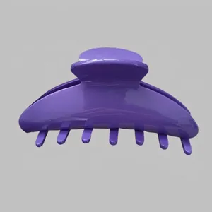 Detailed view of a purple acetate hair claw clip with a glossy finish on a gray background