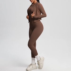 Three-piece brown yoga set featuring a zip-up jacket, slim top, and high-waist leggings