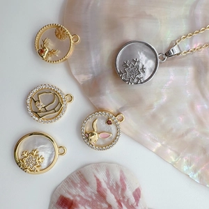 Detail showing 18K gold plated snowflake, reindeer and rabbit shell charms for jewelry making