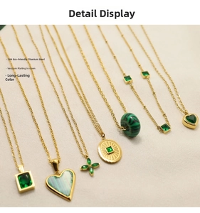 Close-up of gold 304 stainless steel necklaces with green zircon pendants and link details