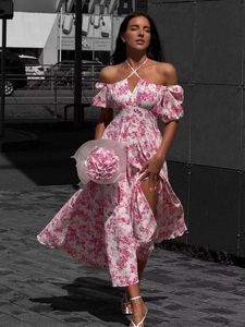 Off-shoulder floral maxi dress with halter neck and side split on white background