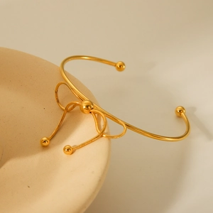 18K gold-plated stainless steel bow open bangle with elegant snake chain detail