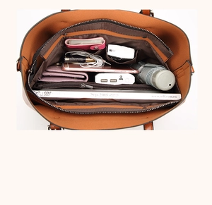 Interior detail of large brown tote showing multi-pocket storage and spacious capacity
