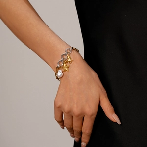 Marine themed mixed metal bracelet featuring starfish charm and baroque pearl on wrist