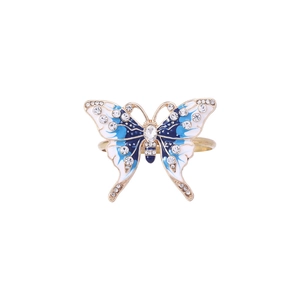 Detail of a golden metal butterfly napkin ring with blue enamel and sparkling rhinestones