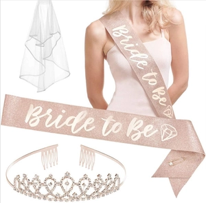 Detail of rose gold glitter Bride To Be sash with white veil and rhinestone tiara set