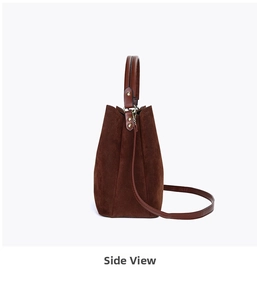 Side view detail of coffee brown suede bucket bag with gold hardware and shoulder strap