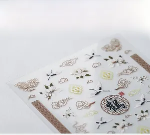 Macro detail of 5D Chinese nail stickers featuring cranes, clouds, and floral patterns