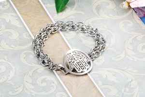 Detail view of silver double-layered chain bracelet with hollow Hamsa Hand charm pendant