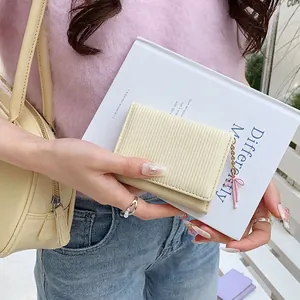 Cute beige pleated tri-fold wallet for women with a stylish pink ribbon metal pendant charm