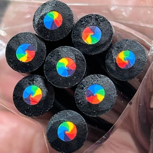 Detailed view of black wood rainbow core pencils set in clear packaging bag