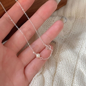 Detail of 925 sterling silver chain necklace with a pearl and crystal bead pendant