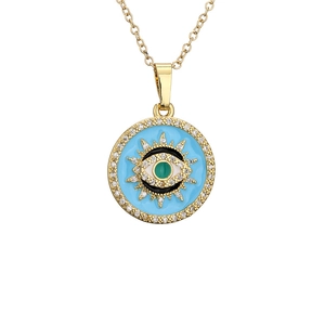 Evil eye pendant necklace with blue enamel, green zircon, and gold sunburst frame