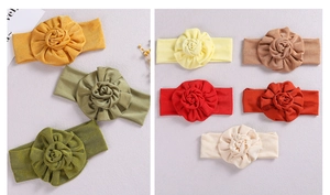 Detail of 8 different colors of soft elastic baby headbands with fabric floral decoration
