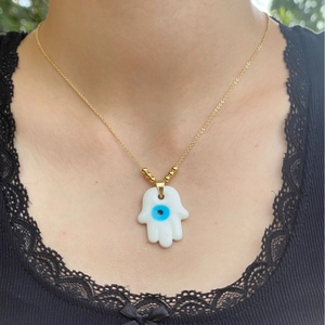 Minimalist 18k gold plated Hamsa hand necklace with blue evil eye pendant on model