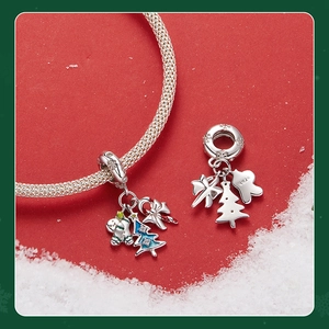 Detailed close-up of 925 sterling silver gingerbread man and blue Christmas tree charms