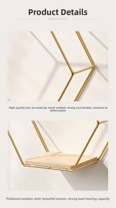 Detail of gold metal frame with thick wood shelves and handmade welding on wall rack