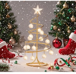 Detailed view of spiral metal Christmas tree with LED star topper and glowing ornaments