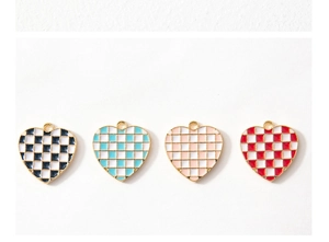 Close-up of checkered heart charms in four colors with gold plating for DIY jewelry