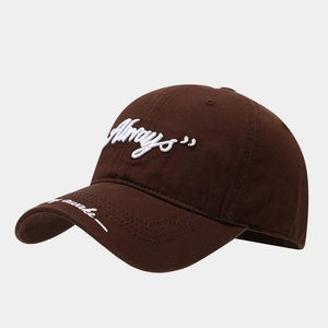 Detail of dark brown cotton baseball cap featuring white embroidery on front and brim