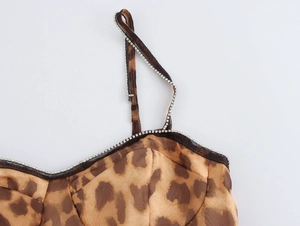 Detail showing leopard print fabric and rhinestone embellishment on shoulder strap