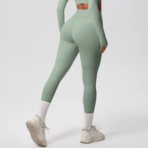 Macro detail of high-waist yoga pants in morandi green with butt-lifting curved seams
