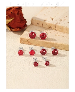 Set of four S925 silver stud earrings with graduated round-cut ruby red stones