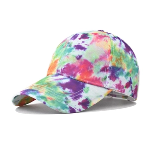 Detail view of colorful tie-dye baseball cap with artistic nebula pattern and stitch detail