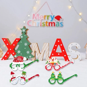Close-up of four festive Christmas paper glasses with snowman and tree holiday designs