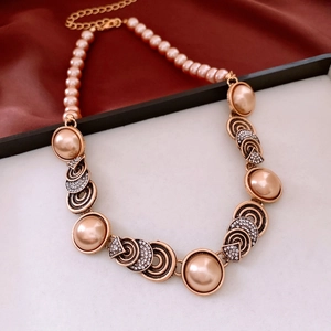 Detailed view of vintage gold necklace with pink faux pearls and lobster clasp closure