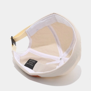 Adjustable beige Docker hat with internal stitching detail and adjustable back strap