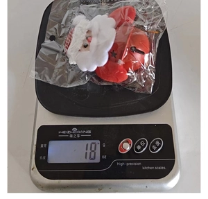 Detailed view of lightweight 18g plush Santa Claus doll with red star-pattern metal bell