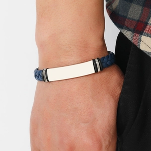 Close-up of men's blue braided leather bracelet with silver metal bar on a wrist