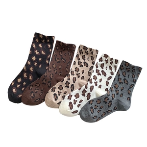Five pairs of leopard print crew socks in assorted colors including khaki and grey