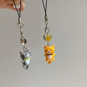 Macro view of grey and orange tabby cat charms with resin beads and metal clips