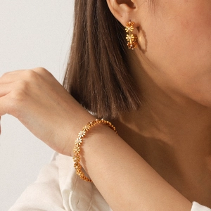 18K gold stainless steel bracelet with white floral charms and matching earrings for women
