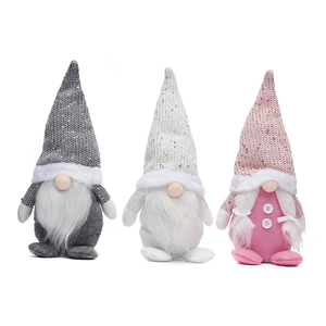 Three sequined Christmas gnomes in gray, white, and pink with plush beards and knit hats