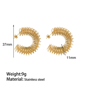 Macro detail of 37mm gold spring hoop earrings made of textured stainless steel