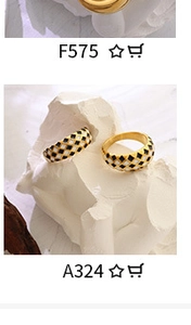 Detailed shot of two wide gold rings with black and white checkerboard enamel pattern
