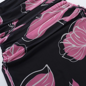 Detail of pink floral print on black mesh fabric with breathable ruched texture