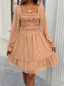 Detail of square neck polka dot dress with elastic smocking and ruffle trim