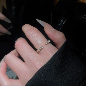 Detail of adjustable zircon open ring with micro-set stones on hand model