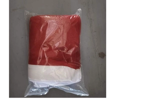 Detail of red and white velvet Christmas chair cover folded in a clear plastic bag
