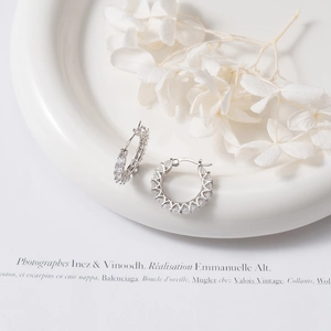 Macro view of S925 silver hoop earrings with clear zircon stones and hallmark detail