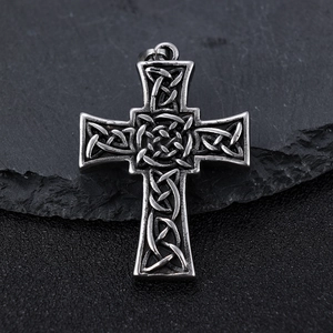 Vintage Celtic cross pendant in silver steel finish on dark stone background